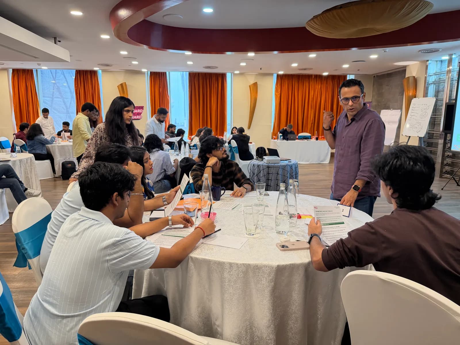 Trainer working with a table group during a corporate session