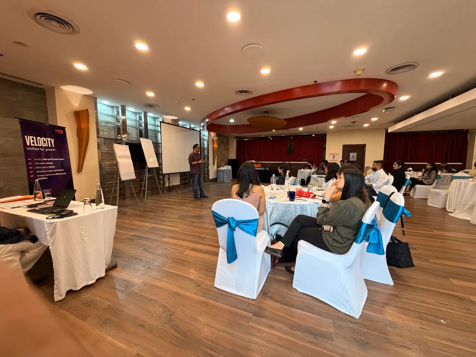 Corporate training room with delegates seated at round tables