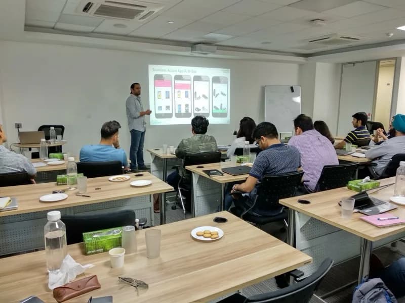 Corporate workshop with a trainer presenting app design slides