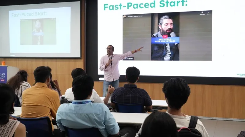 Trainer with a microphone presenting to a seated audience